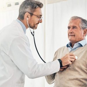 doctor examining patient with stethoscope.