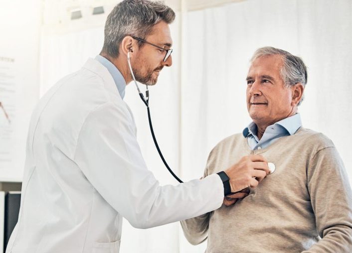 doctor examining patient with stethoscope.